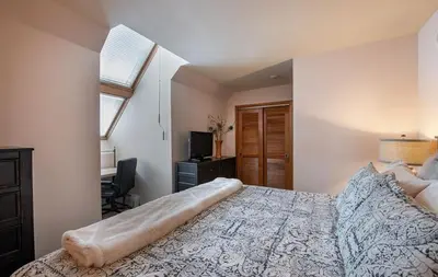 a bedroom with a large bed and a window at Lovely Zephyr Mountain Lodge Condo with Cozy Alcove - Close to Mountain condo in Winter Park