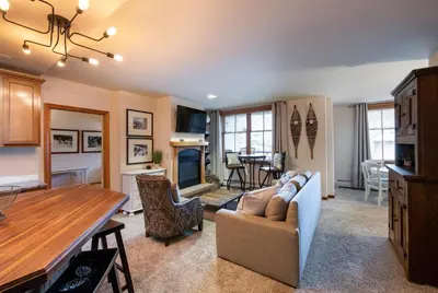 a kitchen and living room with a couch and a table at Lovely Zephyr Mountain Lodge Condo with Cozy Alcove - Close to Mountain condo in Winter Park