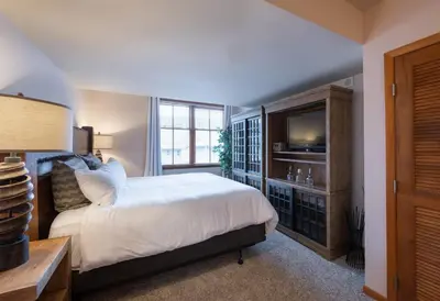 a bedroom with a bed and a television in it at Lovely Zephyr Mountain Lodge Condo with Cozy Alcove - Close to Mountain condo in Winter Park