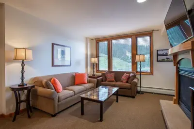a living room with two couches and a fireplace at Remodeled Zephyr Mountain Lodge condo with upgraded furnishings and Slope Side View condo in Winter Park
