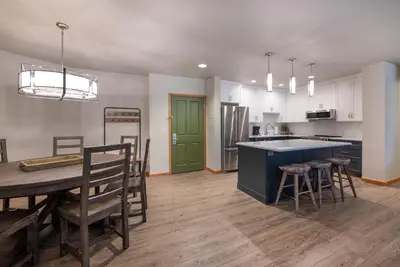 a kitchen and dining room with a table and chairs at Zephyr Mountain Lodge Premium-Rated 2505 in Winter Park