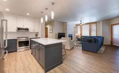an open kitchen and living room with a counter top at Zephyr Mountain Lodge Premium-Rated 2505 in Winter Park