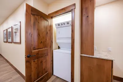 a small kitchen with an oven and a door at Exquisite Zephyr Mountain Lodge condo with 2 king en suite's condo in Winter Park
