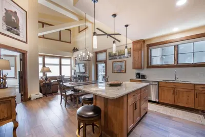 a kitchen with a large island with a counter top at Exquisite Zephyr Mountain Lodge condo with 2 king en suite's condo in Winter Park