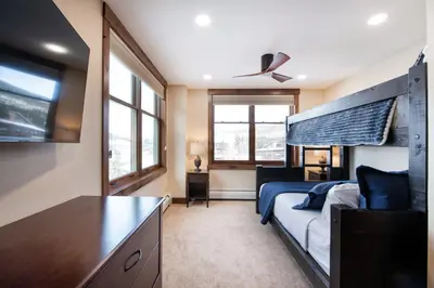 a bedroom with a bed and a large window at Exquisite Zephyr Mountain Lodge condo with 2 king en suite's condo in Winter Park