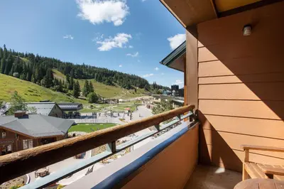 a balcony with a view of a town at Outstanding Zephyr Mountain Lodge Condo with Ski Slope Views condo in Winter Park
