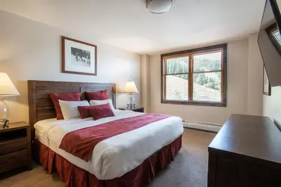 a bedroom with a large bed and a window at Outstanding Zephyr Mountain Lodge Condo with Ski Slope Views condo in Winter Park
