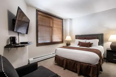 a hotel room with a bed and a window at Outstanding Zephyr Mountain Lodge Condo with Ski Slope Views condo in Winter Park