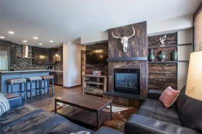 a living room with a couch and a fireplace at Outstanding Zephyr Mountain Lodge Condo with Ski Slope Views condo in Winter Park