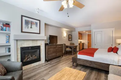 a bedroom with a bed and a fireplace at Cozy Fraser Crossing Founders Pointe Studio Condo Close to Mountain condo in Winter Park