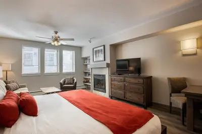 a bedroom with a bed and a flat screen tv at Cozy Fraser Crossing Founders Pointe Studio Condo Close to Mountain condo in Winter Park