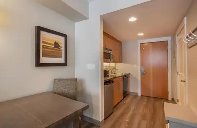 a kitchen with a table and a dining room at Cozy Fraser Crossing Founders Pointe Studio Condo Close to Mountain condo in Winter Park