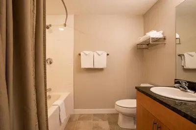 a bathroom with a sink and a toilet and a tub at Cozy Fraser Crossing Founders Pointe Studio Condo Close to Mountain condo in Winter Park