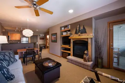 a living room with a couch and a fireplace at Zephyr Mountain Lodge Premium-Rated 1506 in Winter Park