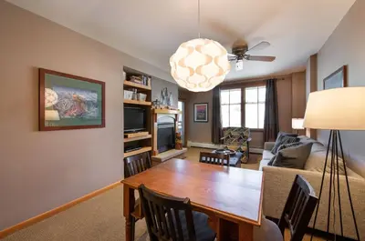 a living room with a table and a couch at Zephyr Mountain Lodge Premium-Rated 1506 in Winter Park