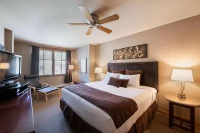 a bedroom with a large bed and a ceiling fan at Zephyr Mountain Lodge Premium-Rated 1506 in Winter Park