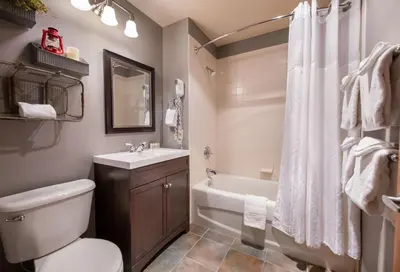 a bathroom with a toilet and a sink and a tub at Zephyr Mountain Lodge Premium-Rated 1506 in Winter Park