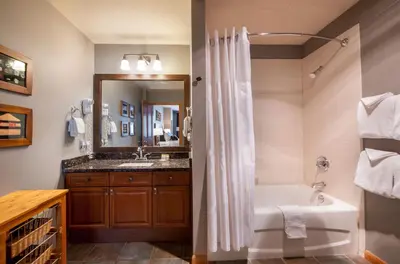 a bathroom with a tub and a sink at Zephyr Mountain Lodge Premium-Rated 1506 in Winter Park