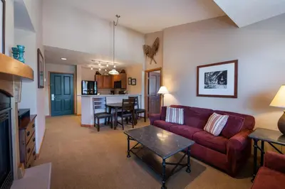 a living room with a couch and a table at Zephyr Mountain Lodge Select-Rated 1604 in Winter Park