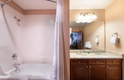 a bathroom with a tub and a sink and a shower at Zephyr Mountain Lodge Select-Rated 1604 in Winter Park