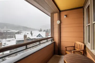 a balcony with a table and a window with a view at Zephyr Mountain Lodge Select-Rated 1604 in Winter Park