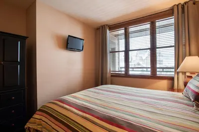 a bedroom with a bed and a window at Zephyr Mountain Lodge Select-Rated 1604 in Winter Park