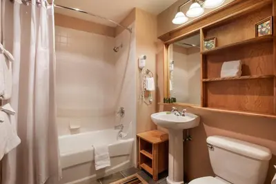 a bathroom with a sink and a toilet and a tub at Zephyr Mountain Lodge Select-Rated 1604 in Winter Park