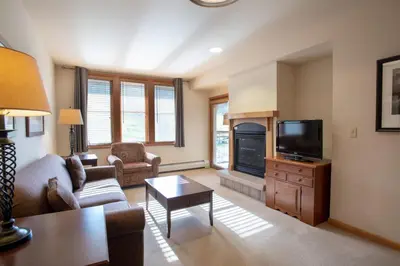 a living room with a couch and a tv at Spectacular Zephyr Mountain Lodge Condo with Ski Slope View condo in Winter Park