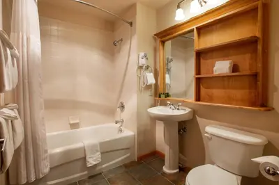 a bathroom with a tub and a toilet and a sink at Spectacular Zephyr Mountain Lodge Condo with Ski Slope View condo in Winter Park