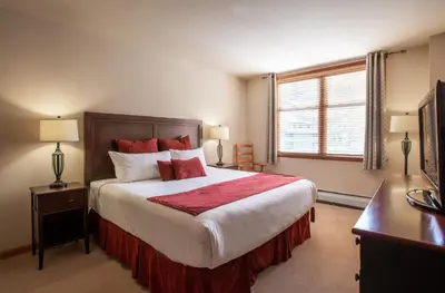 a bedroom with a large bed and a window at Spectacular Zephyr Mountain Lodge Condo with Ski Slope View condo in Winter Park