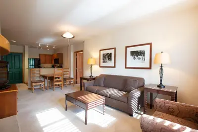 a living room with a couch and a table at Spectacular Zephyr Mountain Lodge Condo with Ski Slope View condo in Winter Park