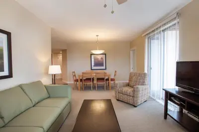 a living room with a couch and a dining room at Comfortable Fraser Crossing Founders Pointe Condo Near Gondola with Onsite Ski Storage condo in Winter Park