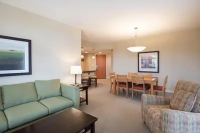 a living room with a couch and a dining room at Comfortable Fraser Crossing Founders Pointe Condo Near Gondola with Onsite Ski Storage condo in Winter Park