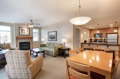 a living room with a table and a dining room at Comfortable Fraser Crossing Founders Pointe Condo Near Gondola with Onsite Ski Storage condo in Winter Park