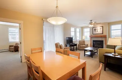 a dining room and living room with a table and chairs at Comfortable Fraser Crossing Founders Pointe Condo Near Gondola with Onsite Ski Storage condo in Winter Park