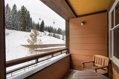 a room with a window with a view of a snow covered field at Cozy Zephyr Mountain Lodge condo with sweeping views of Arapahoe National Forest condo in Winter Park