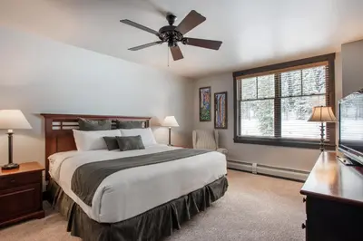 a bedroom with a bed and a ceiling fan at Cozy Zephyr Mountain Lodge condo with sweeping views of Arapahoe National Forest condo in Winter Park