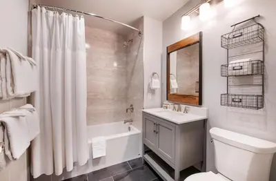 a bathroom with a sink and a toilet and a shower at Cozy Zephyr Mountain Lodge condo with sweeping views of Arapahoe National Forest condo in Winter Park