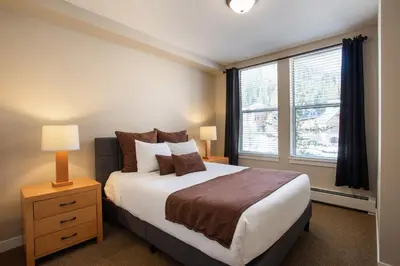 a bedroom with a large bed and a window at Townhome Style Fraser Crossing Founders Pointe Condo with Upgraded Furnishings and washer dryer condo in Winter Park