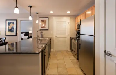 a kitchen with a stainless steel refrigerator and a sink at Townhome Style Fraser Crossing Founders Pointe Condo with Upgraded Furnishings and washer dryer condo in Winter Park