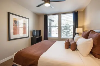 a bedroom with a large bed with a window at Townhome Style Fraser Crossing Founders Pointe Condo with Upgraded Furnishings and washer dryer condo in Winter Park