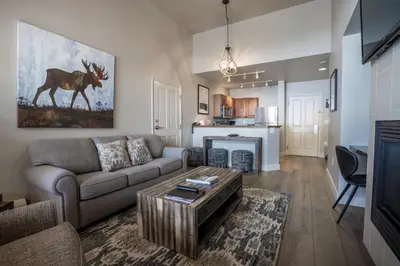 a living room with a couch and a table at Cozy Zephyr Mountain Lodge Condo with Spectacular View of Gondola condo in Winter Park