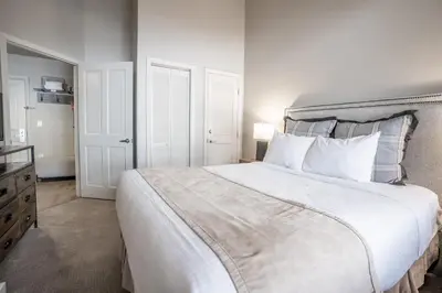a bedroom with a large white bed with white pillows at Cozy Zephyr Mountain Lodge Condo with Spectacular View of Gondola condo in Winter Park