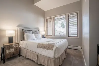 a bedroom with a large bed and a window at Cozy Zephyr Mountain Lodge Condo with Spectacular View of Gondola condo in Winter Park