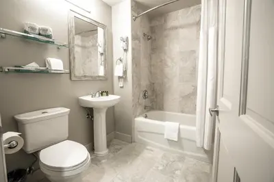 a bathroom with a toilet and a sink and a bath tub at Cozy Zephyr Mountain Lodge Condo with Spectacular View of Gondola condo in Winter Park