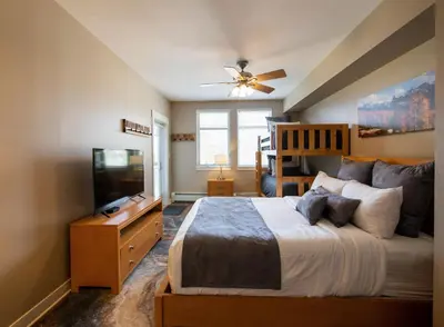 a bedroom with a bed and a flat screen tv at Winter Park FF Premium Rated Condo 3506 in Winter Park