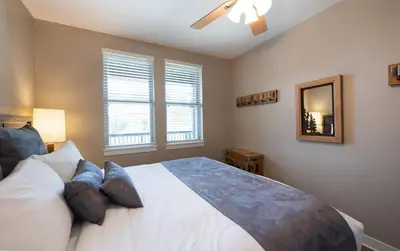 a bedroom with a bed and a mirror and windows at Winter Park FF Premium Rated Condo 3506 in Winter Park