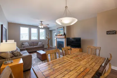 a dining room and living room with a wooden table at Winter Park FF Premium Rated Condo 3506 in Winter Park