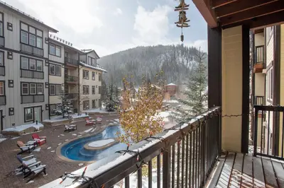 a balcony with a view of a swimming pool at Deluxe Fraser Crossing Founders Pointe Condo with Ski Storage and washer dryer condo in Winter Park