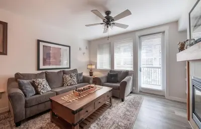 a living room with a couch and a table at Deluxe Fraser Crossing Founders Pointe Condo with Ski Storage and washer dryer condo in Winter Park